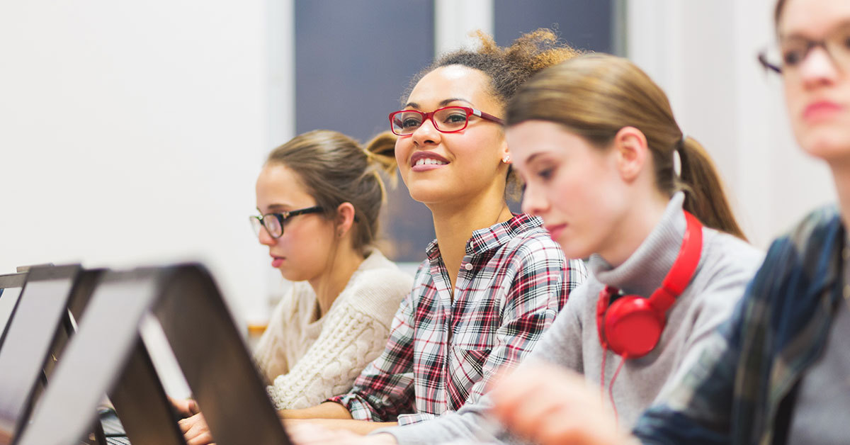 Young women in business casual wear working on computers.