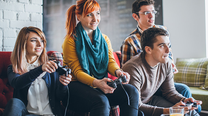 Two young men and two young women playing video games together.