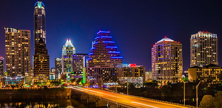 Processed, time-lapse digital photo of the Austin, Texas skyline at night.